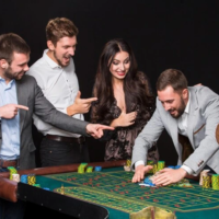 group-young-people-roulette-table-black-background-young-man-rejoices-victory_639032-625 (1)